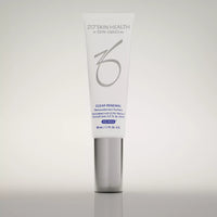 A white cosmetic tube with a metallic silver cap, standing upright on a reflective light gray surface. The tube is branded 'ZO'SKIN HEALTH' and labeled 'CLEAR RENEWAL'.