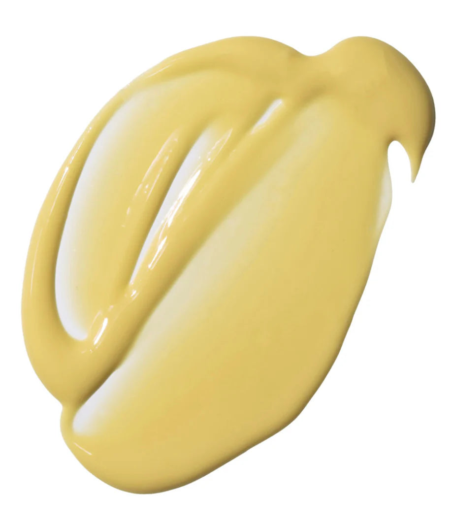 A thick, glossy swatch of pale yellow cream on a plain white background.