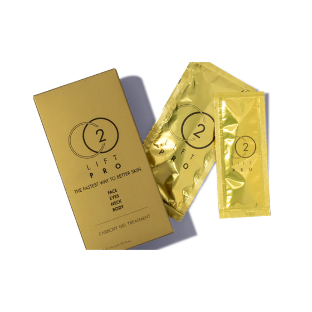 Gold skincare packaging from Lift Pro, including a rectangular box and two foil sachets, arranged on a white background with soft shadows.