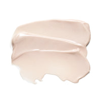 A thick, creamy swatch of light beige serum, showing smooth texture and glossy highlights on a solid white background.