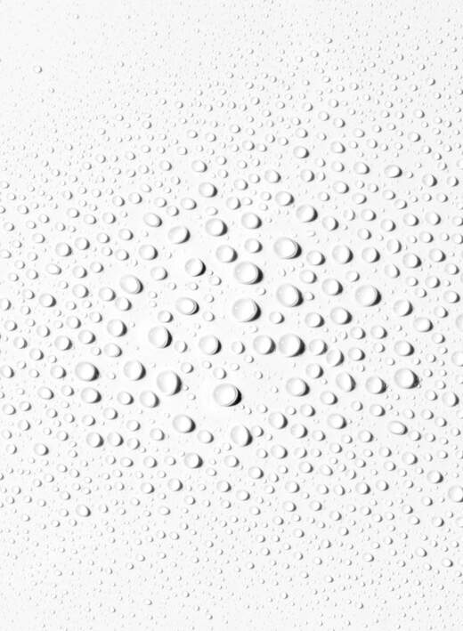 Textured white surface with spray circular liquid droplets