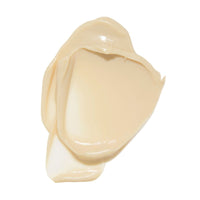 A dollop of smooth, glossy beige cream swatch on a solid white background.