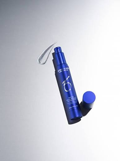 Blue cosmetic bottle with pump on a gray background