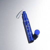 Blue cosmetic bottle with pump on a gray background